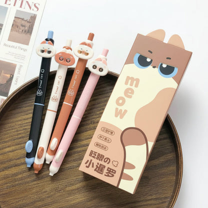 Four cute sassy cat-themed gel pens with a packaging box on a wooden surface.