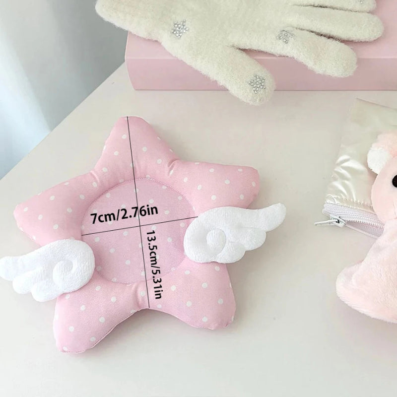 Pink star-shaped coaster with white polka dots and cloud wings on a light surface. The image displaying the measurements of the coaster