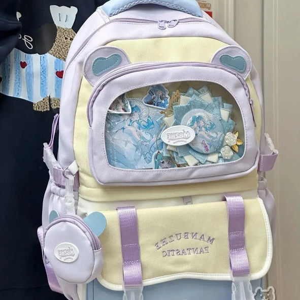 Beary cute Pastel-colored backpack with decorative elements held by a person. blue version