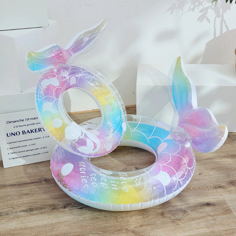 Colorful inflatable ring with mermaid tail design on a wooden surface