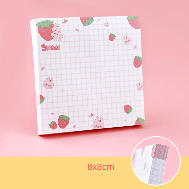 Kawaii sticky notes pad with strawberry pattern on a pink background
