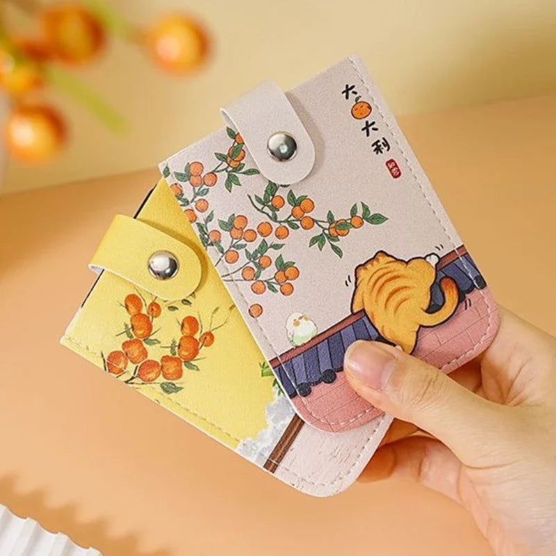 Small pouch with cartoon design held by a hand against a warm-toned background