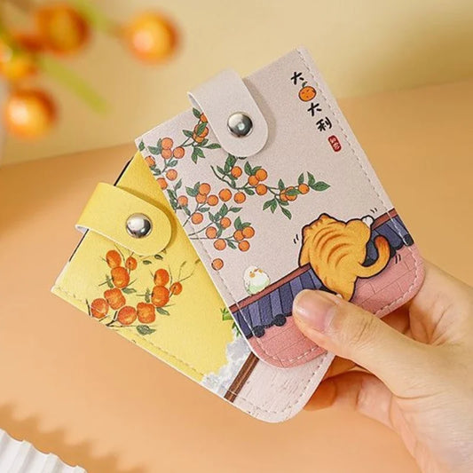 Small pouch with cartoon design held by a hand against a warm-toned background