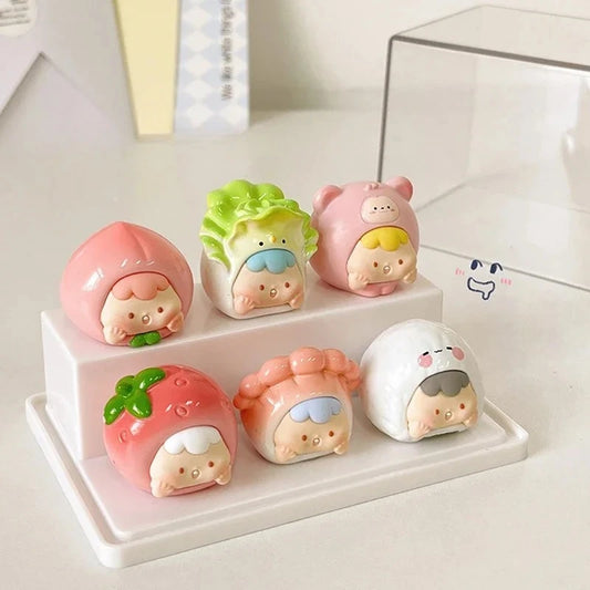 Six cute pastel character figurines arranged on a white display stand. The kawaii characters resemble stylized food items like a peach, cabbage, pork belly, strawberry, pink bun, and white rice ball, with soft pastel colors and small smiling faces.