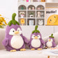 Front view of Kawaii Cute Penguin Eggplant Plushies on a couch