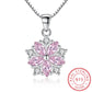 Sakura Cherry Blossom Necklace the light pink version is hanging on a white background with a sterling silver chain