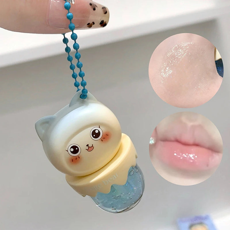 Cute character lip oil keychain with close-up insets of a glossy surface and lips