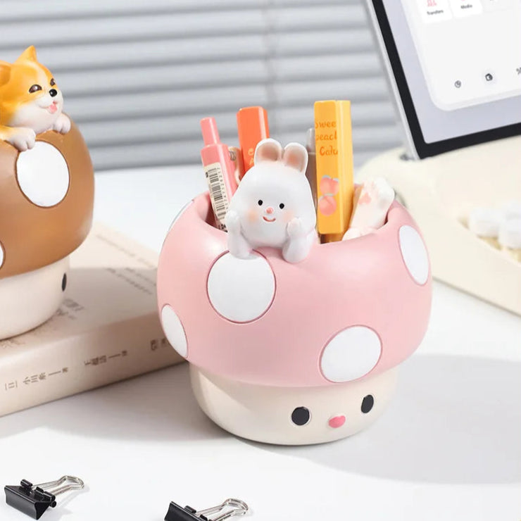 Cute mushroom-shaped pen holder with stationery items on a desk.