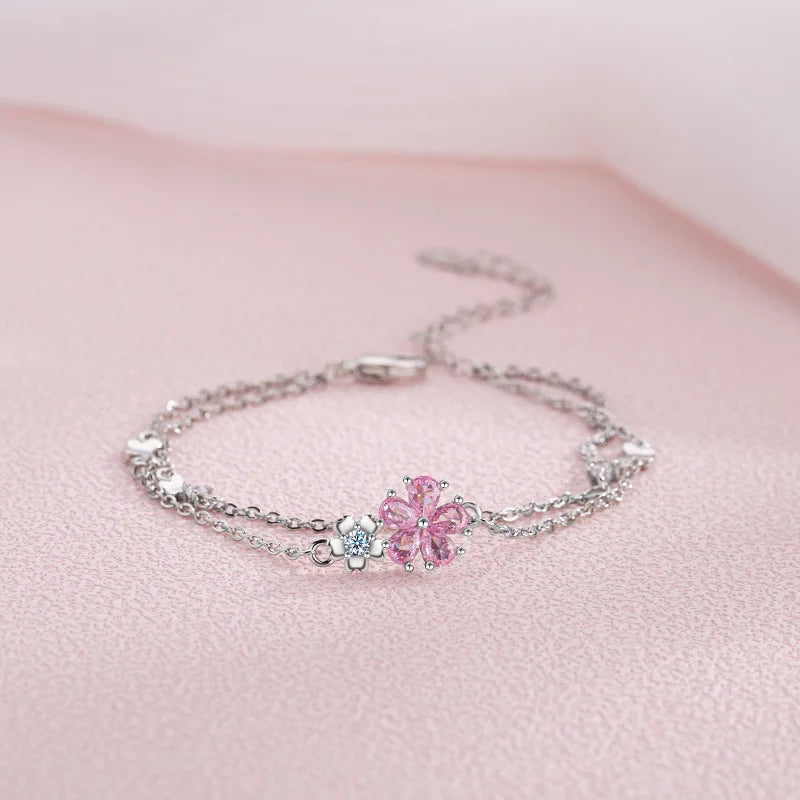 Sakura Cherry Blossom Bracelet displayed on a pink background