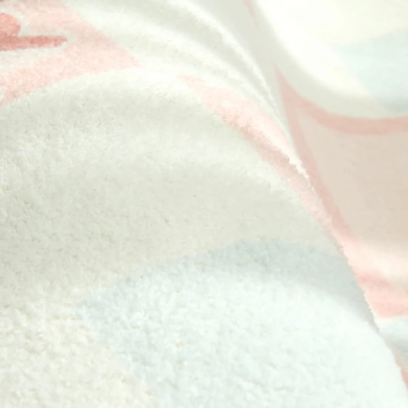 Close-up of a textured fabric with pink and white patterns