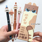 Set of four cute sassy cartoon-style pens with a cat-themed packaging box on a white background.