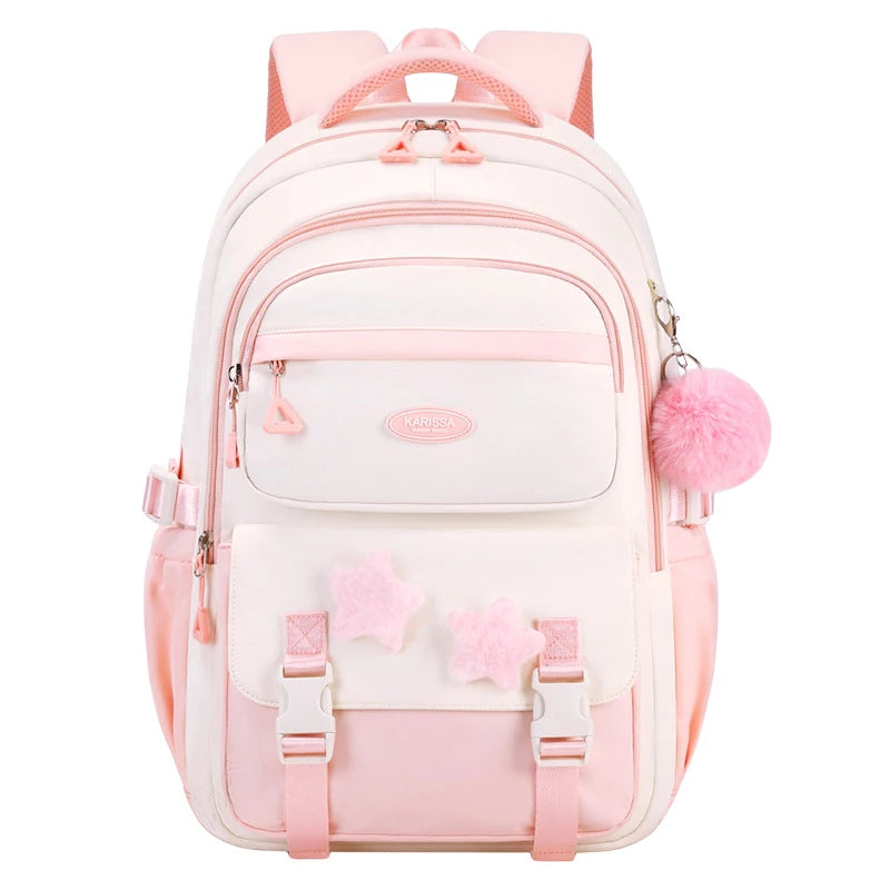 Pink and white backpack with pom-pom details on a white background
