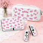 This image is showing the Cute Pink Bows Switch Case white edition on a pink background and surface with a white table cloth and a vase full of pink blossom flowers.