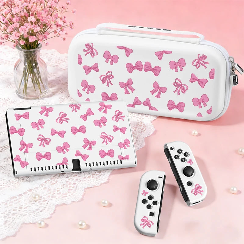 This image is showing the Cute Pink Bows Switch Case white edition on a pink background and surface with a white table cloth and a vase full of pink blossom flowers.