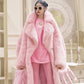 Person wearing a pink fur coat and outfit in an elegant interior setting with 'Lautaro' branding.