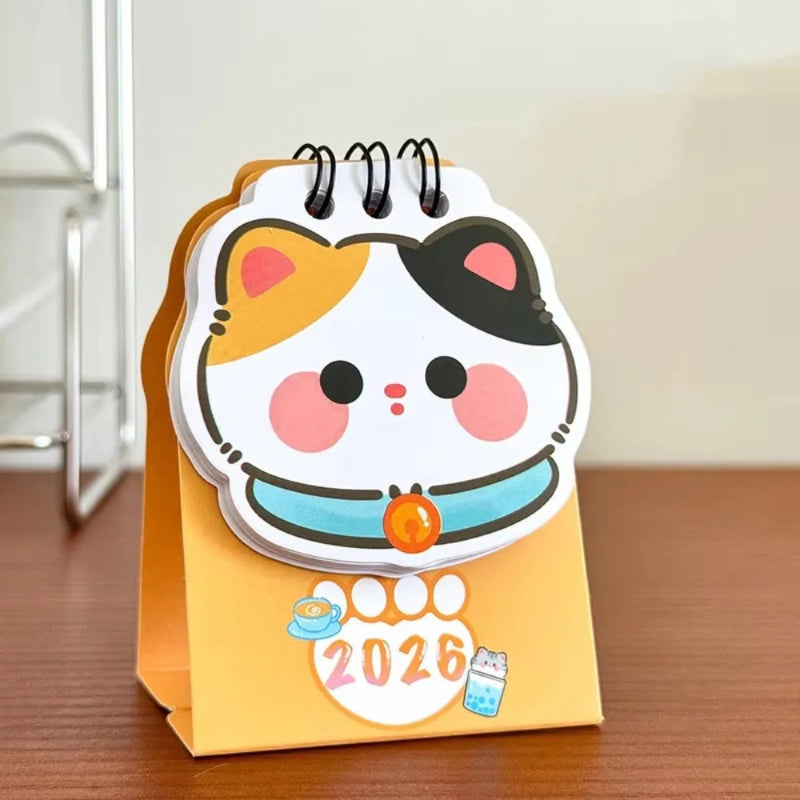 Small desk calendar with a cute animal design on a wooden surface