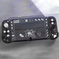 Black handheld gaming console with white graphics on a gray background
