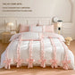 White duvet cover with pink bows and ribbons on a bed in a bedroom setting.