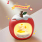Decorative apple-shaped night light with a Kawaii cat design inside, on a neutral background.