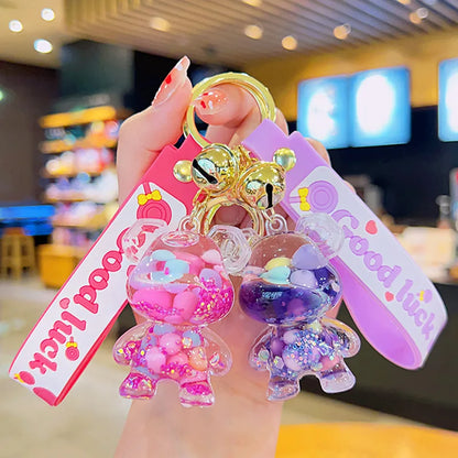 Colorful keychain with cartoon character and 'Good Luck' tag held by a hand in a casual setting.