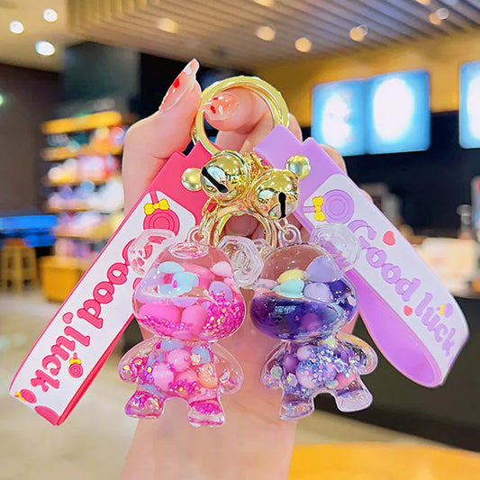 Colorful keychain with cartoon character and 'Good Luck' tag held by a hand in a casual setting.
