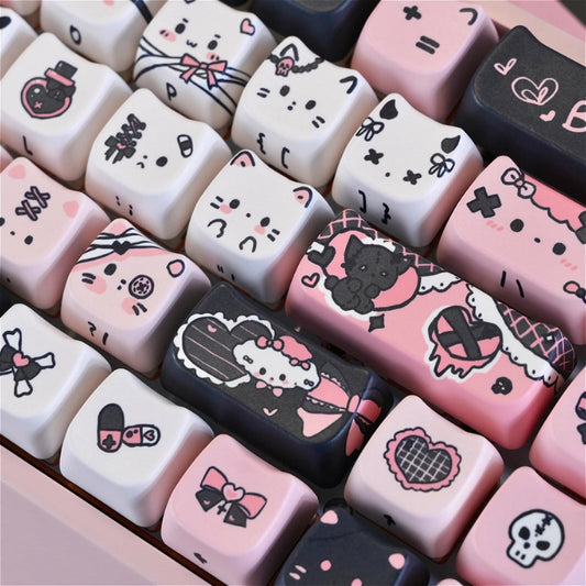 This image is showing a close up of the Kawaii Creepy Cuties Keyboard Keycaps, showing the designs on the keycaps such as cute cat faces  with skull necklace around their ear or bandages round their tiny tummies.
