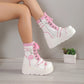 White platform boots with pink accents worn by a person, on a neutral background.