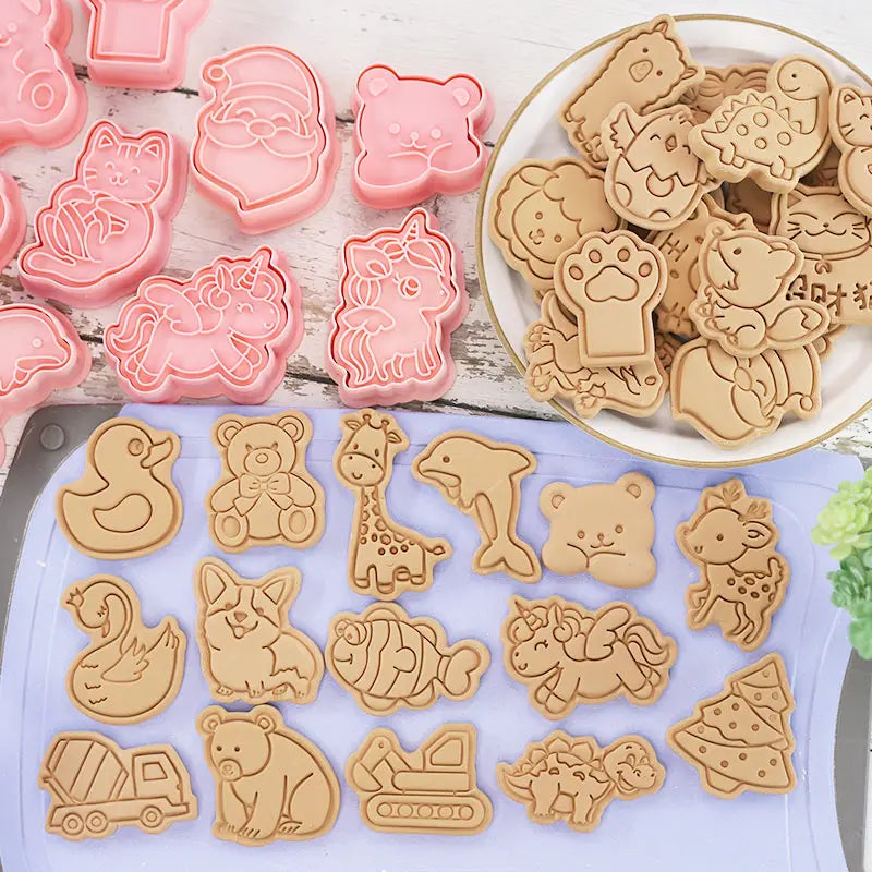 Set of animal-shaped cookie cutters and cookies on a wooden surface