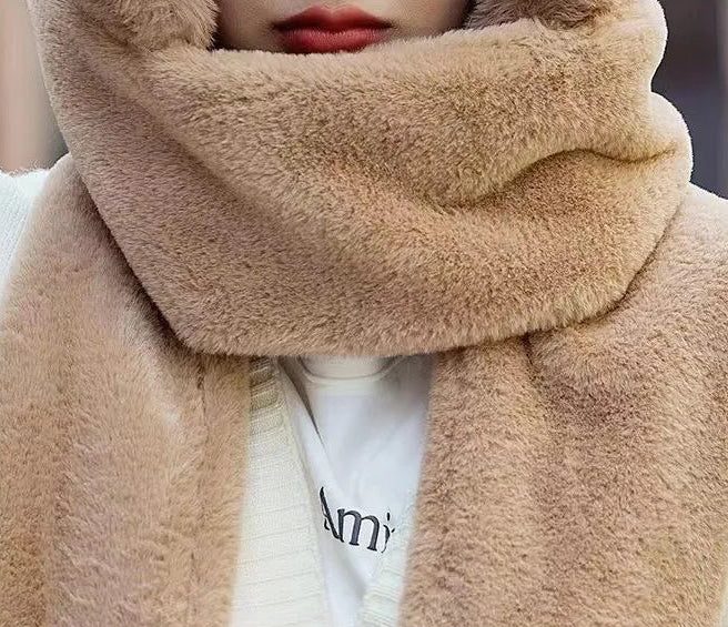 Close-up of a person wearing a beige scarf with a blurred background