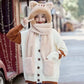 Person wearing a fluffy white cardigan with brown accents and a matching kawaii  hat with ears on a street.
