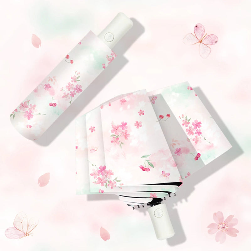Handheld Pretty Cherry Blossoms Umbrella with floral design on a light pink background