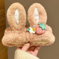 fluffy kawaii bunny headband with bunny ears and strawberry design held by a hand.