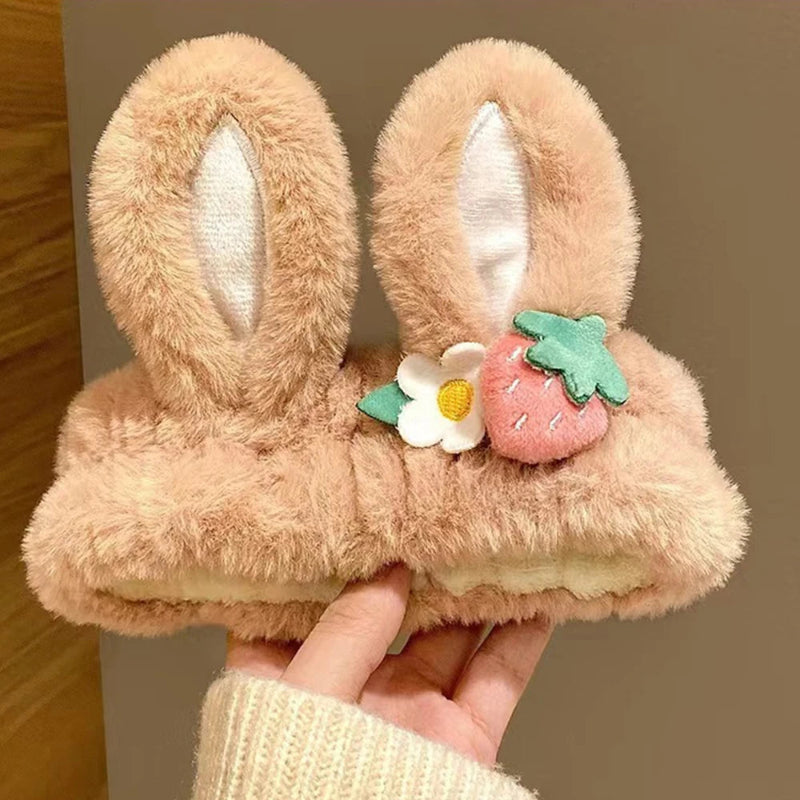 fluffy kawaii bunny headband with bunny ears and strawberry design held by a hand.