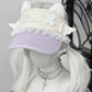Visor hat with decorative elements on a mannequin head with white hair