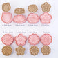 Set of flower-shaped cookie cutters with dimensions on a white background