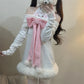 Person wearing a white outfit with a pink bow and holding a cell phone