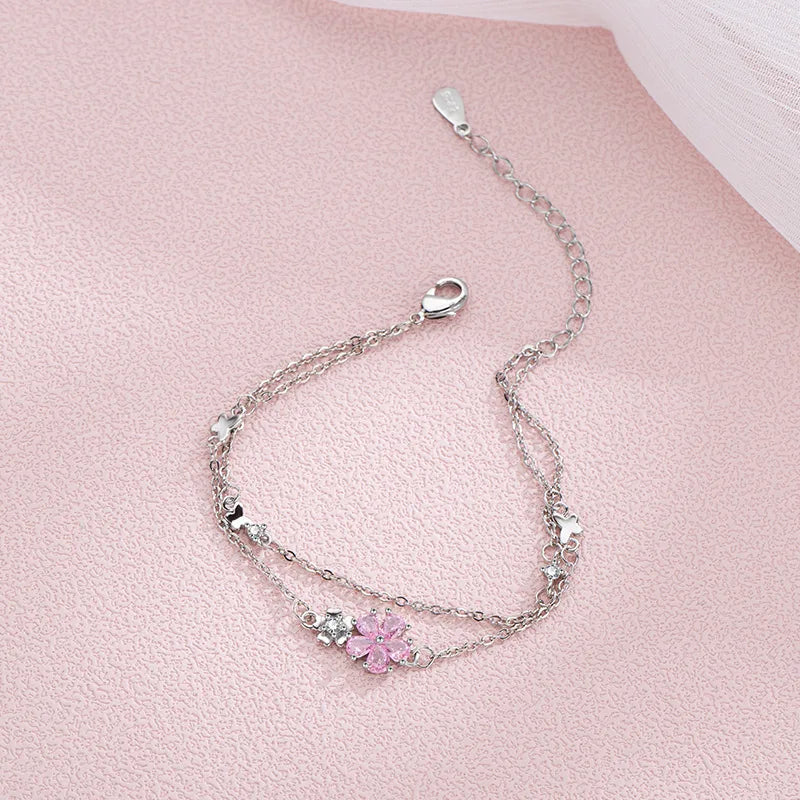 Sakura Cherry Blossom Bracelet displayed on a pink background