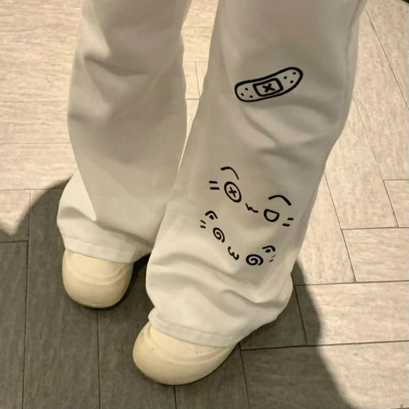 Light grey pants with black designs on a tiled floor