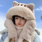 Person wearing a fluffy cat-themed hat against a blue sky.