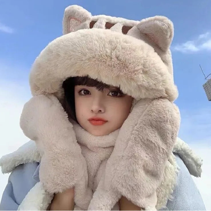 Person wearing a fluffy cat-themed hat against a blue sky.