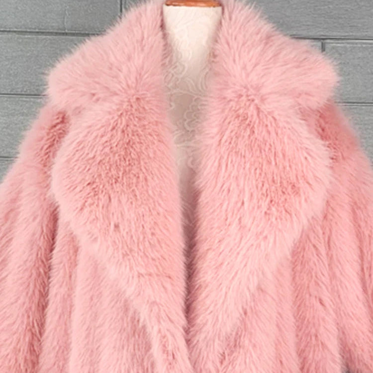 Pink fur coat on a mannequin against a gray background