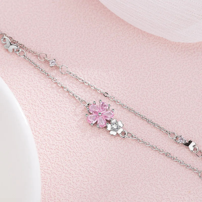 Sakura Cherry Blossom Bracelet displayed on a pink background