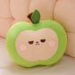 Plush toy shaped like a green apple with a unimpressed face on a beige background
