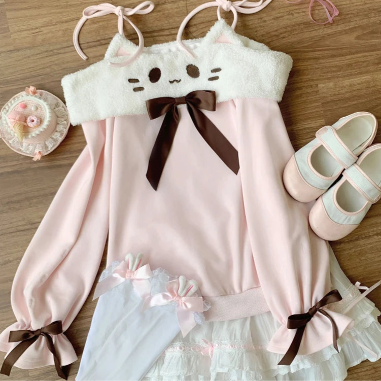 Pink and white top, white skirt, and shoes on a wooden surface.