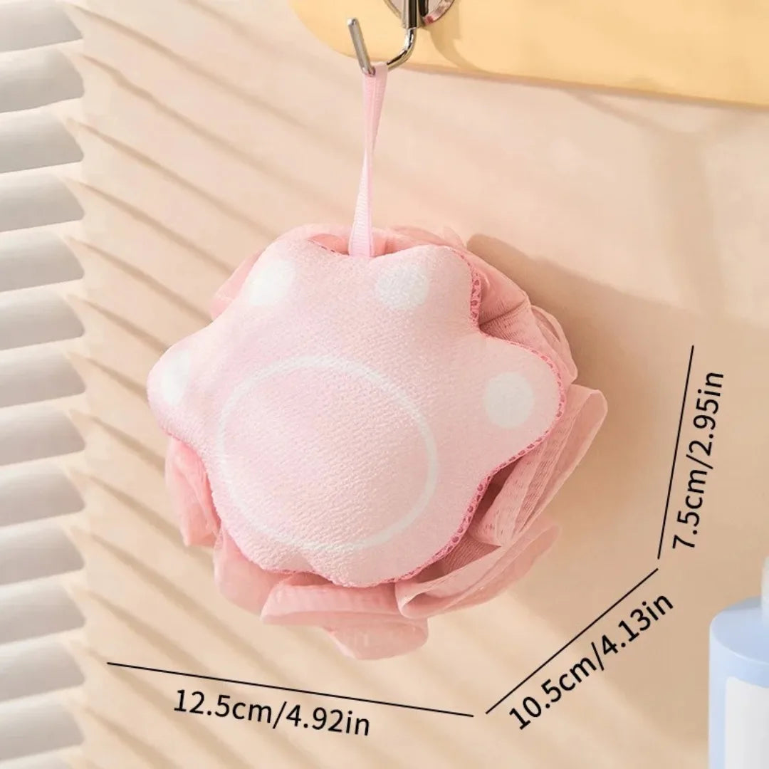 Pink bath pouf with measurements on a neutral background