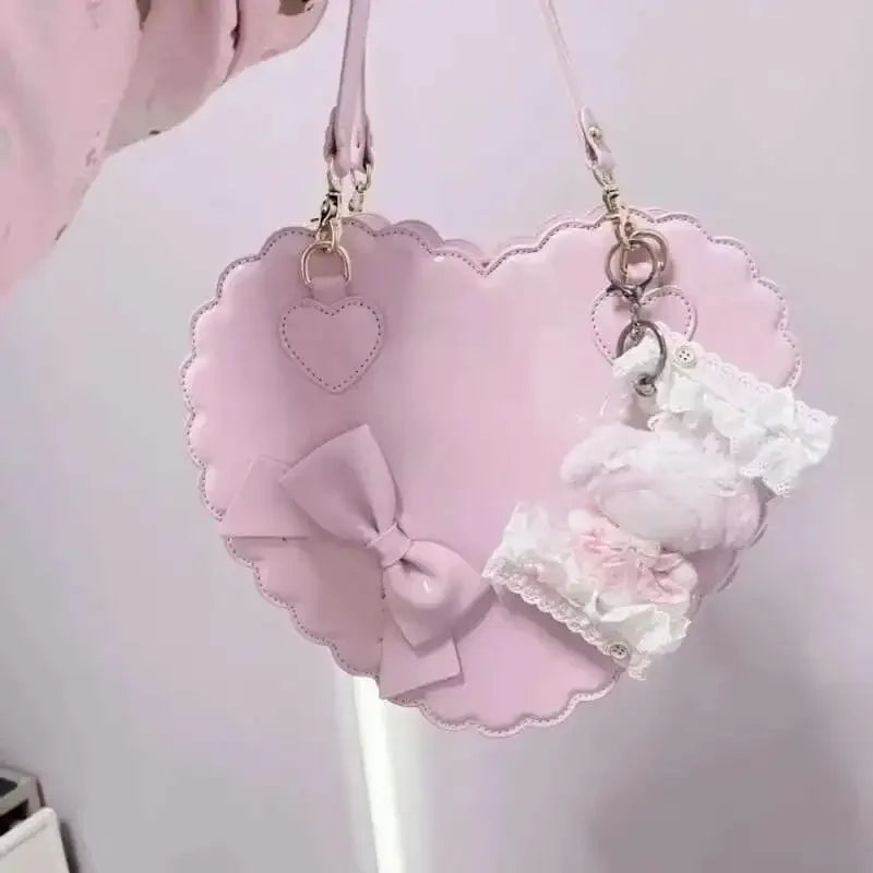 Heart-shaped pink bag with bow and lace details on a light pink background