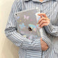 Person holding a clear ipad case with butterfly designs on the ipad case