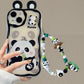 women holding kawaii panda samsung phone case with beaded charm attached and ears on a beige background the panda on the case is sat eating bamboo
