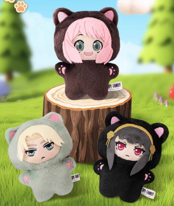 Three plush toys with animal ears on a grassy background