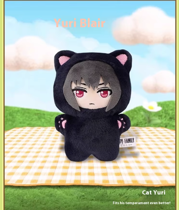 Plush toy with cat ears and paws on a checkered blanket with a scenic background